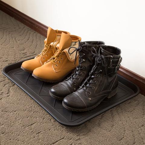 Stalwart boot tray in entryway keeping mud off hardwood floors