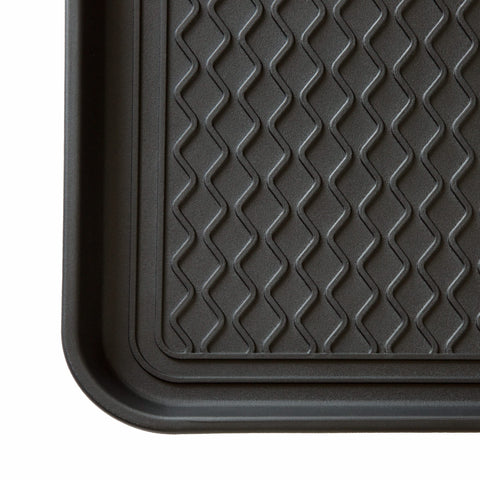 Stalwart boot tray in black blends with decor while protecting floors.