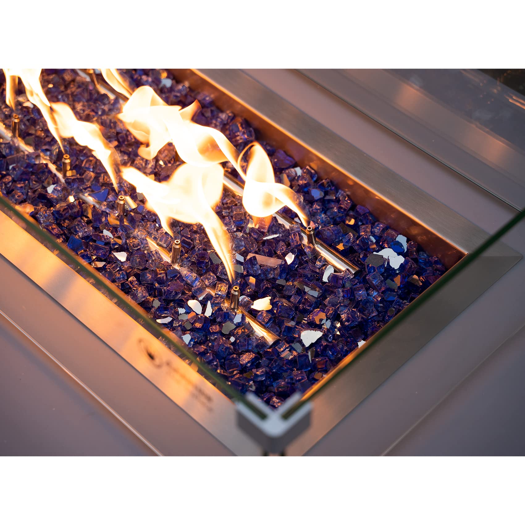 Stanbroil cobalt blue reflective fire glass creating ambient glow outdoors.