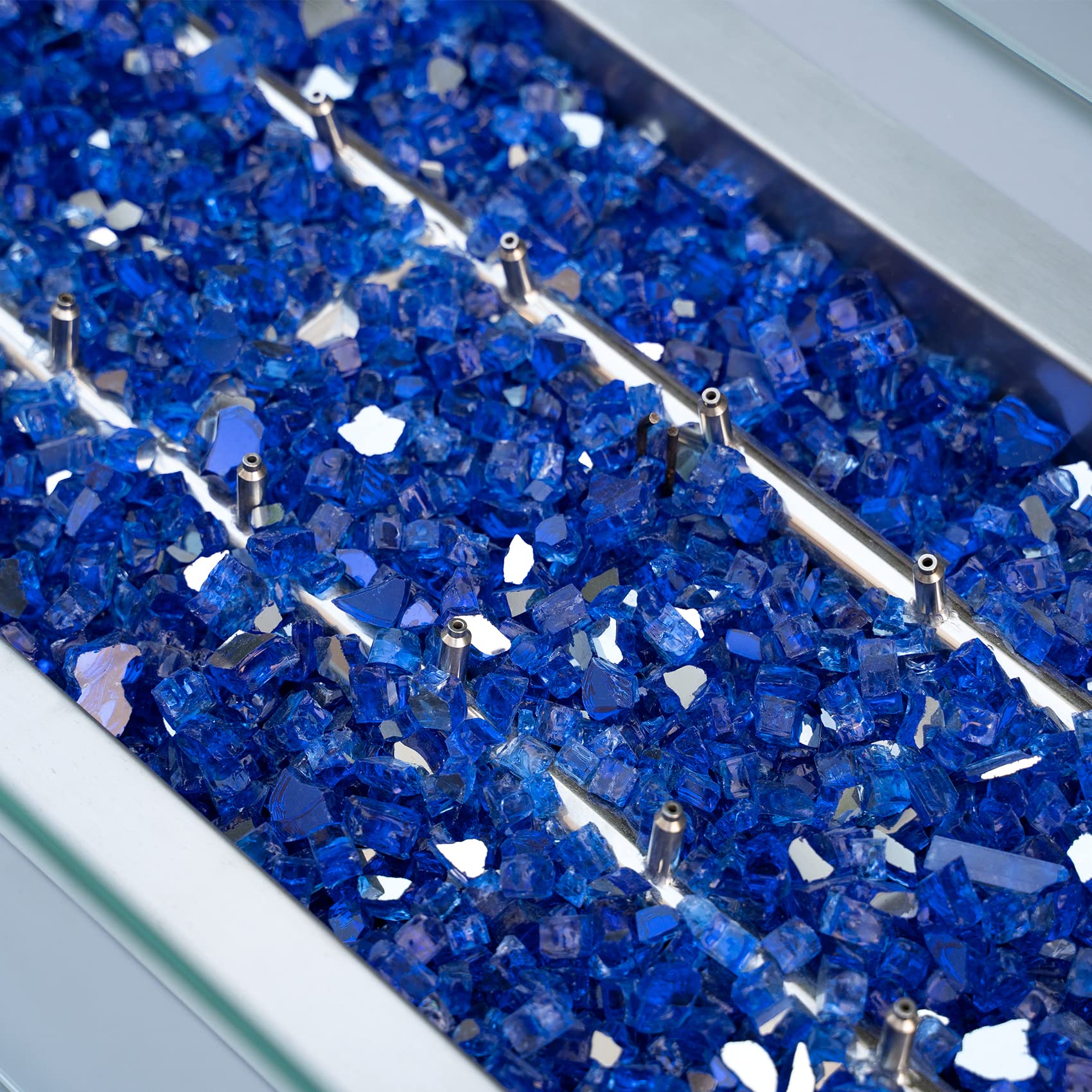 Stanbroil cobalt blue fire glass in fire pit for even glow with gas setup.