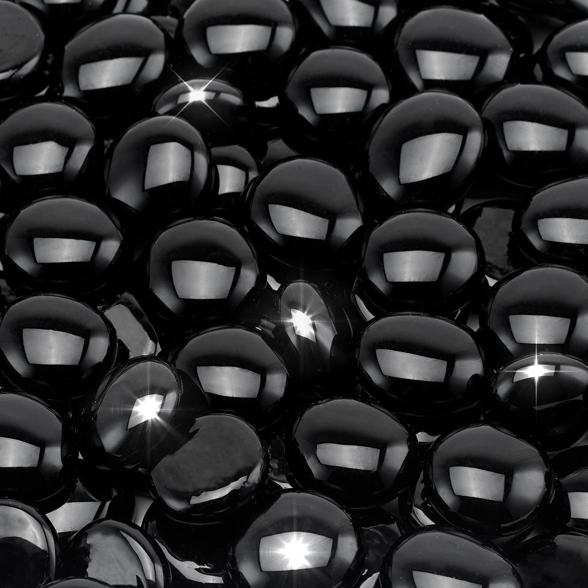 Stanbroil onyx black luster fire glass drops in a fireplace create shimmering glow
