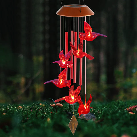 STF solar powered wind chime lights up at night in a garden setting