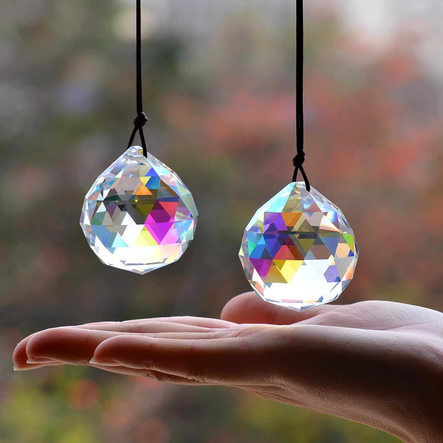 Stino Ball ABColor suncatcher prism shines in sunlight to cast colorful patterns in a sunny window