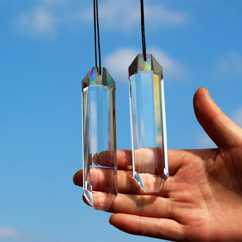 Stino rectangle crystal prism duo catching sunlight to cast rainbows.