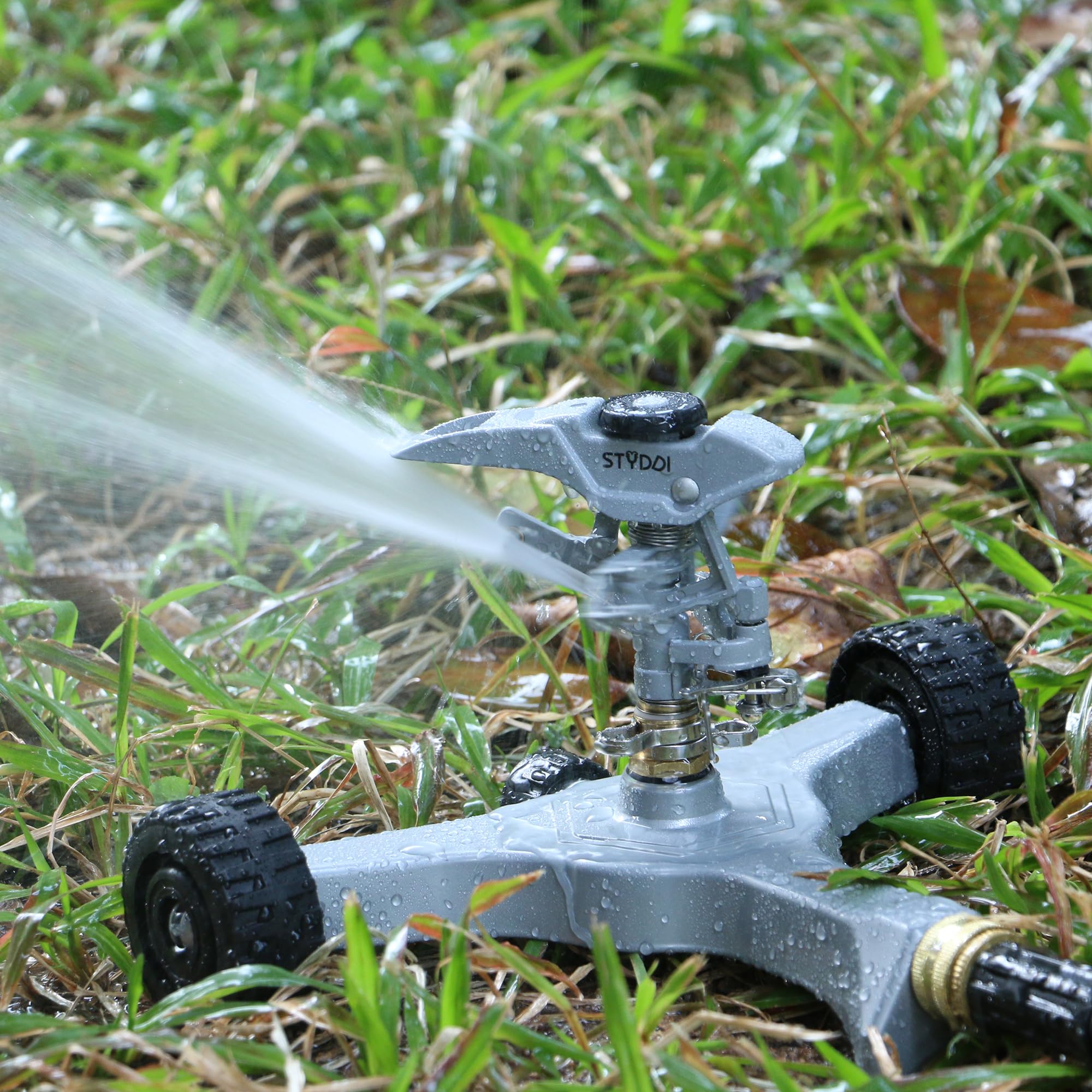 STYDDI metal pulsating sprinkler with wheeled base, front view for easy yard repositioning.