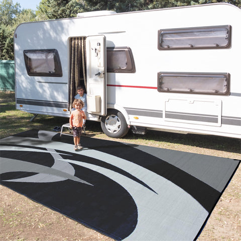 Stylish Camping reversible mat on the beach for quick sand-free setup.