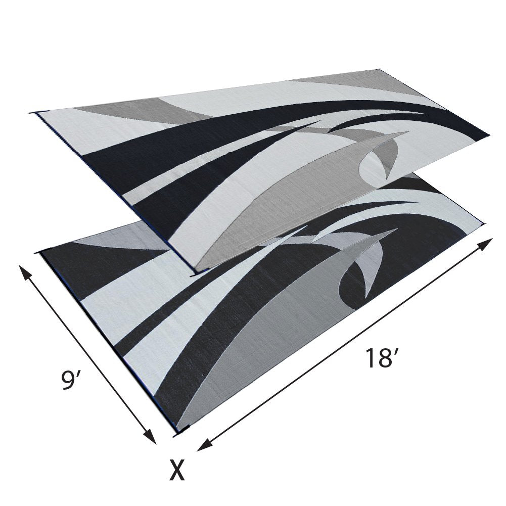 Stylish Camping reversible mat on an RV patio defines outdoor space.