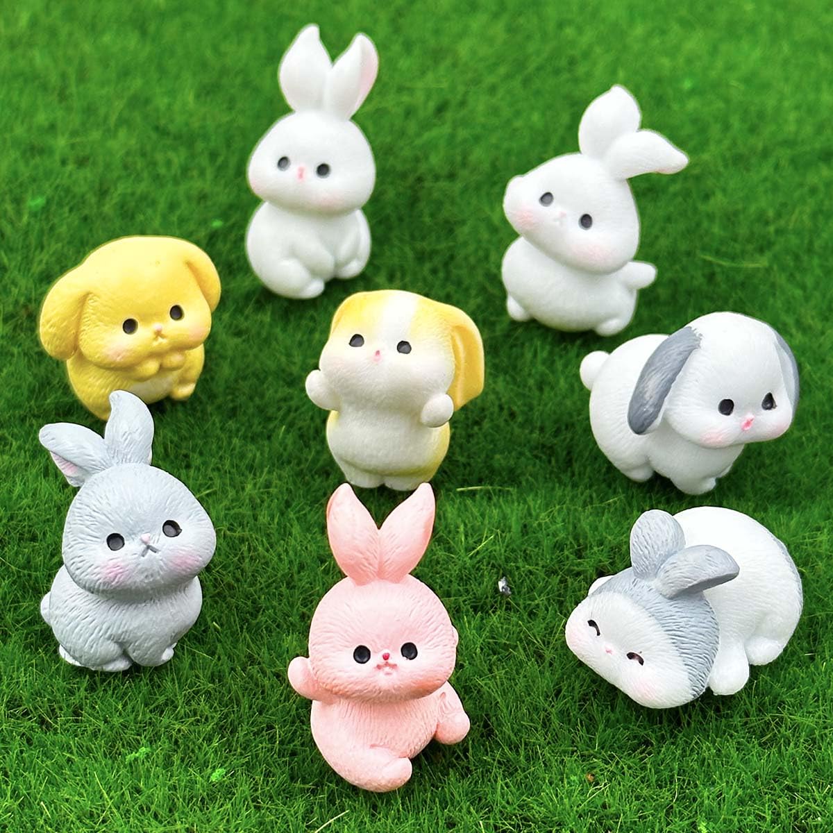 Suartus resin bunnies in varied poses add festive charm to fairy gardens.