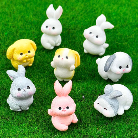 Suartus resin bunnies in varied poses add festive charm to fairy gardens.