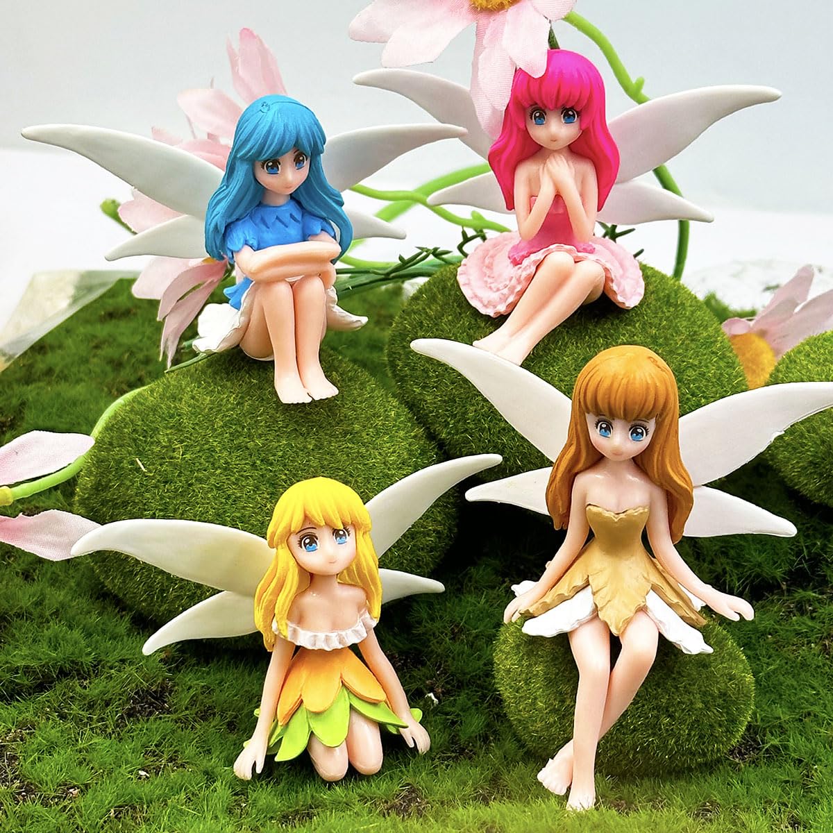 Suartus miniature fairy figurines in four colors for fairy garden displays.