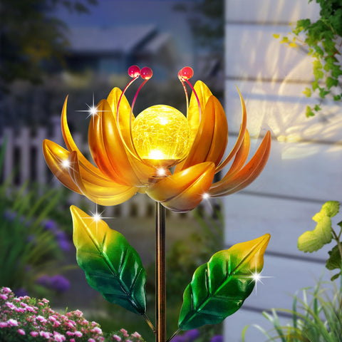 SUCUY solar lotus wind spinner with warm glow in garden at night