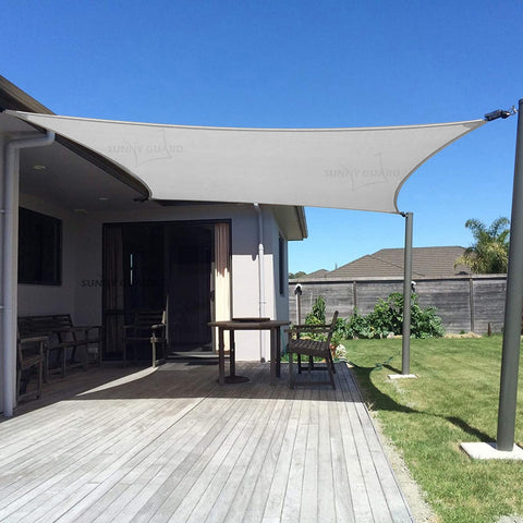 Sunny Guard sun shade sail 7x13 rectangle installed in a backyard for cooling shade.