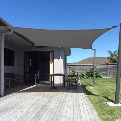 Sunny Guard sun shade sail in dark grey over backyard providing cooling shade.