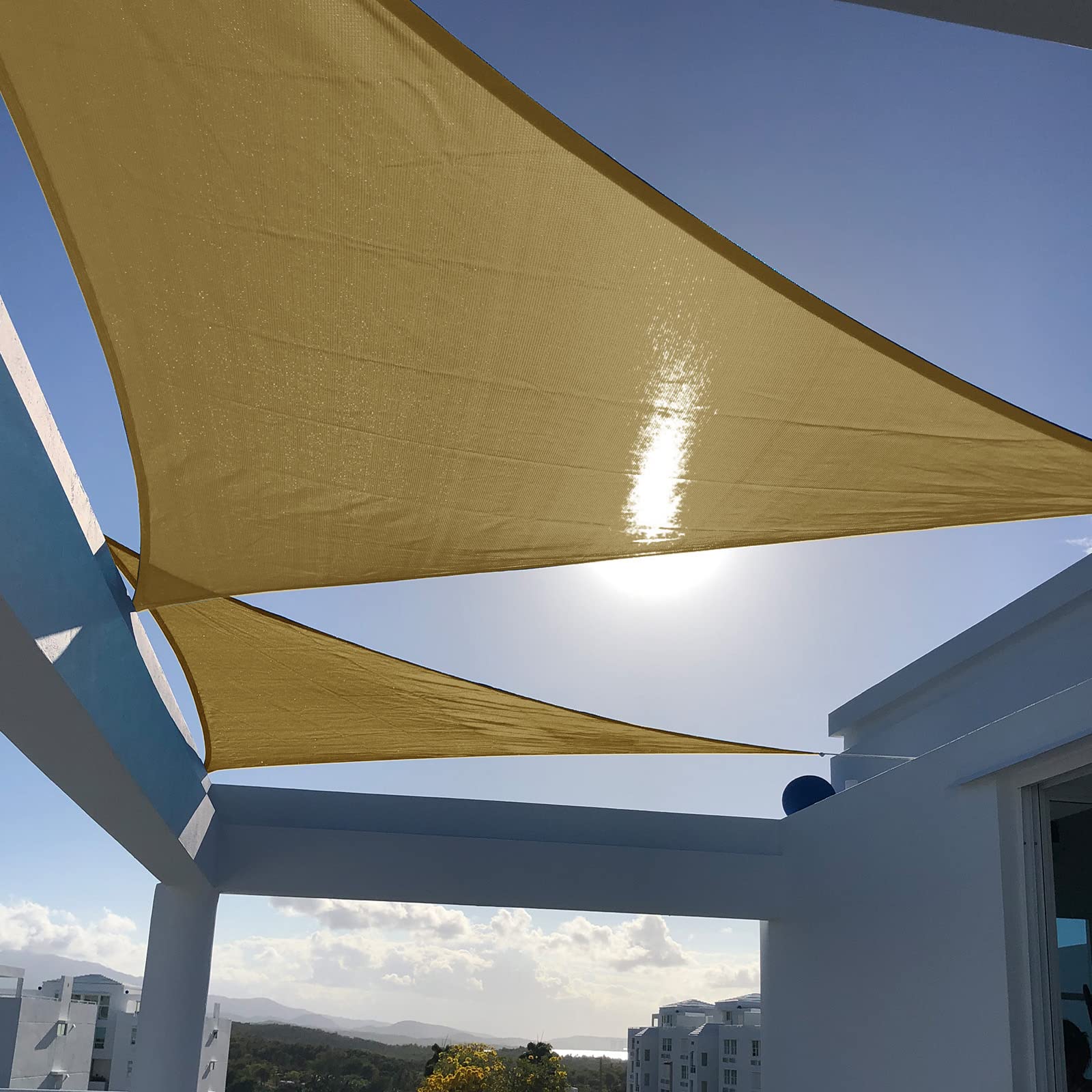Sunny Guard sun shade sail triangle blocks UV rays for a shaded backyard.