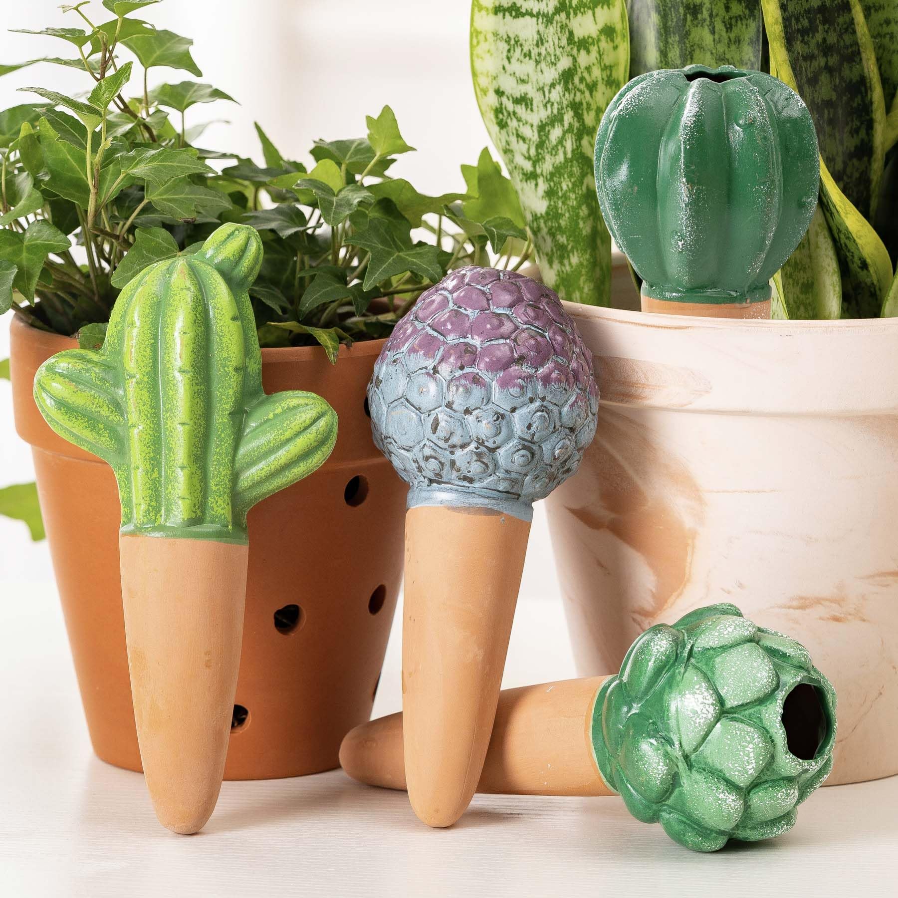 SURE YUESI terra cotta cactus watering globe in pot, delivering steady moisture to indoor plants.