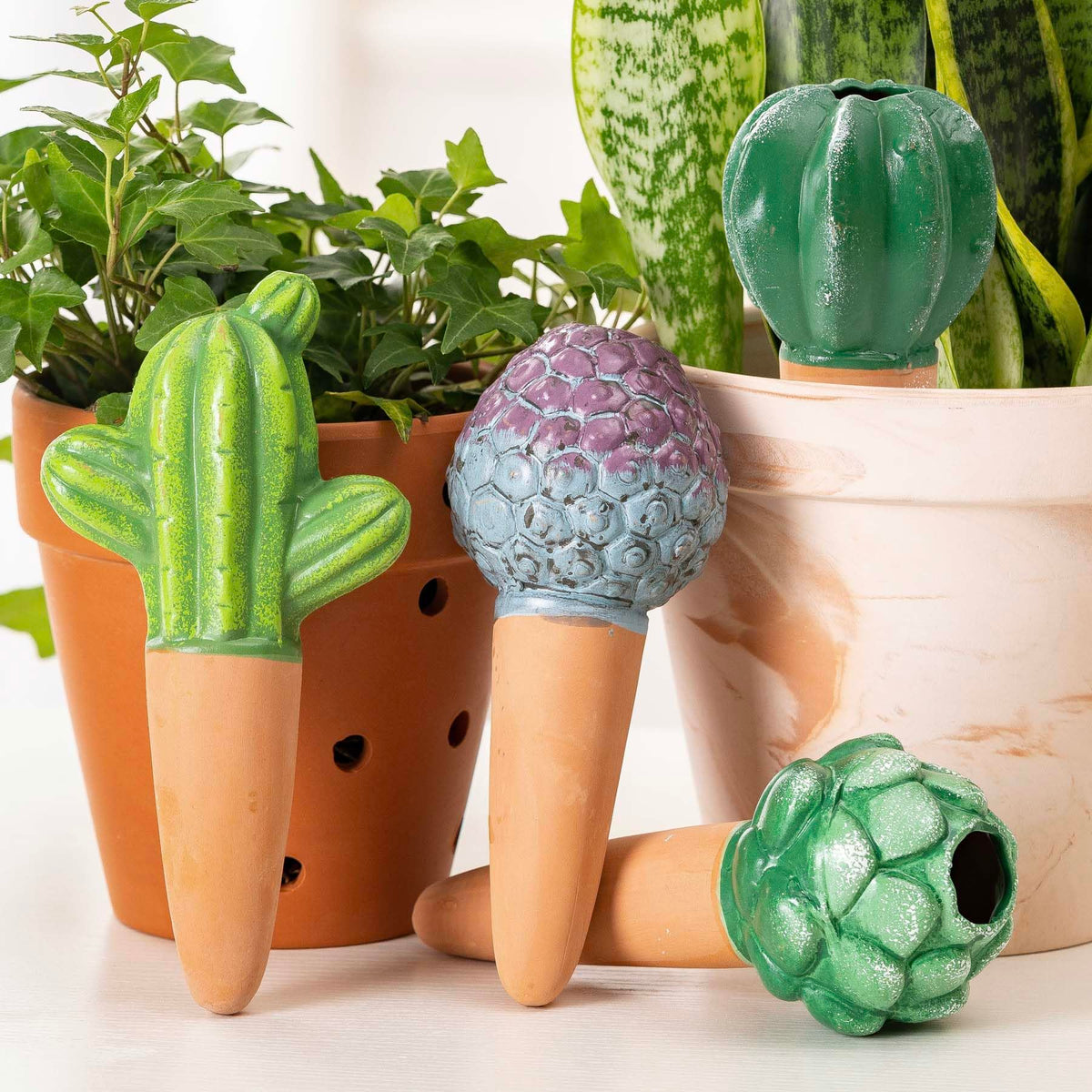 SURE YUESI terra cotta cactus watering globe in pot, delivering steady moisture to indoor plants.