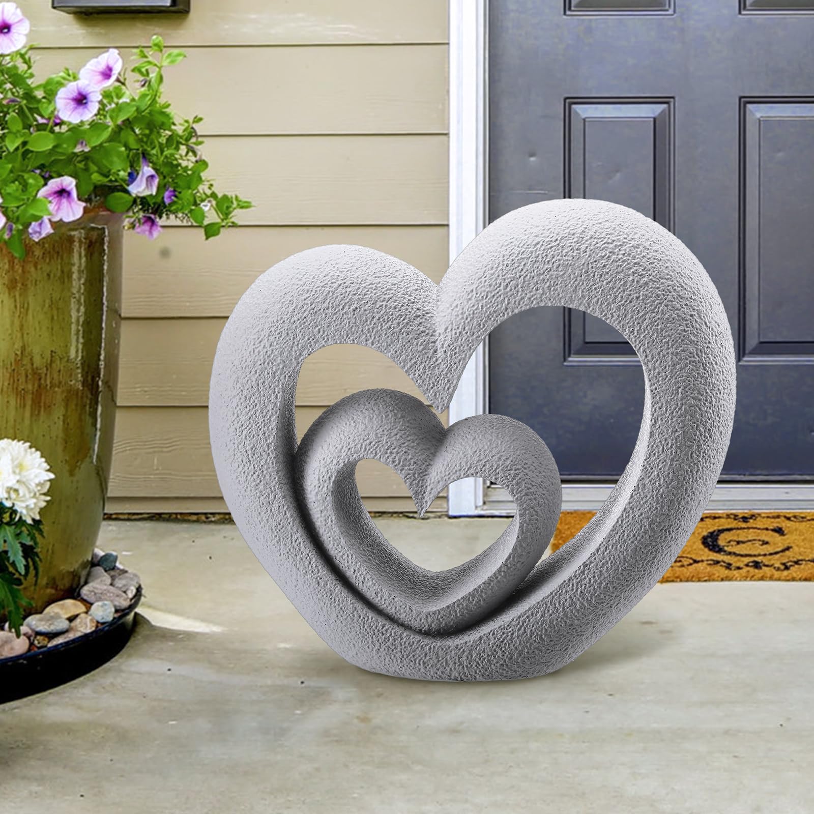 Suzile Nesting Heart Garden Statue detail close-up, carved hearts symbolize enduring love.