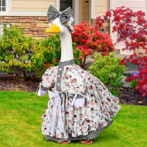 Suzile porch goose outfit on a goose statue demonstrates coordinated festive look.