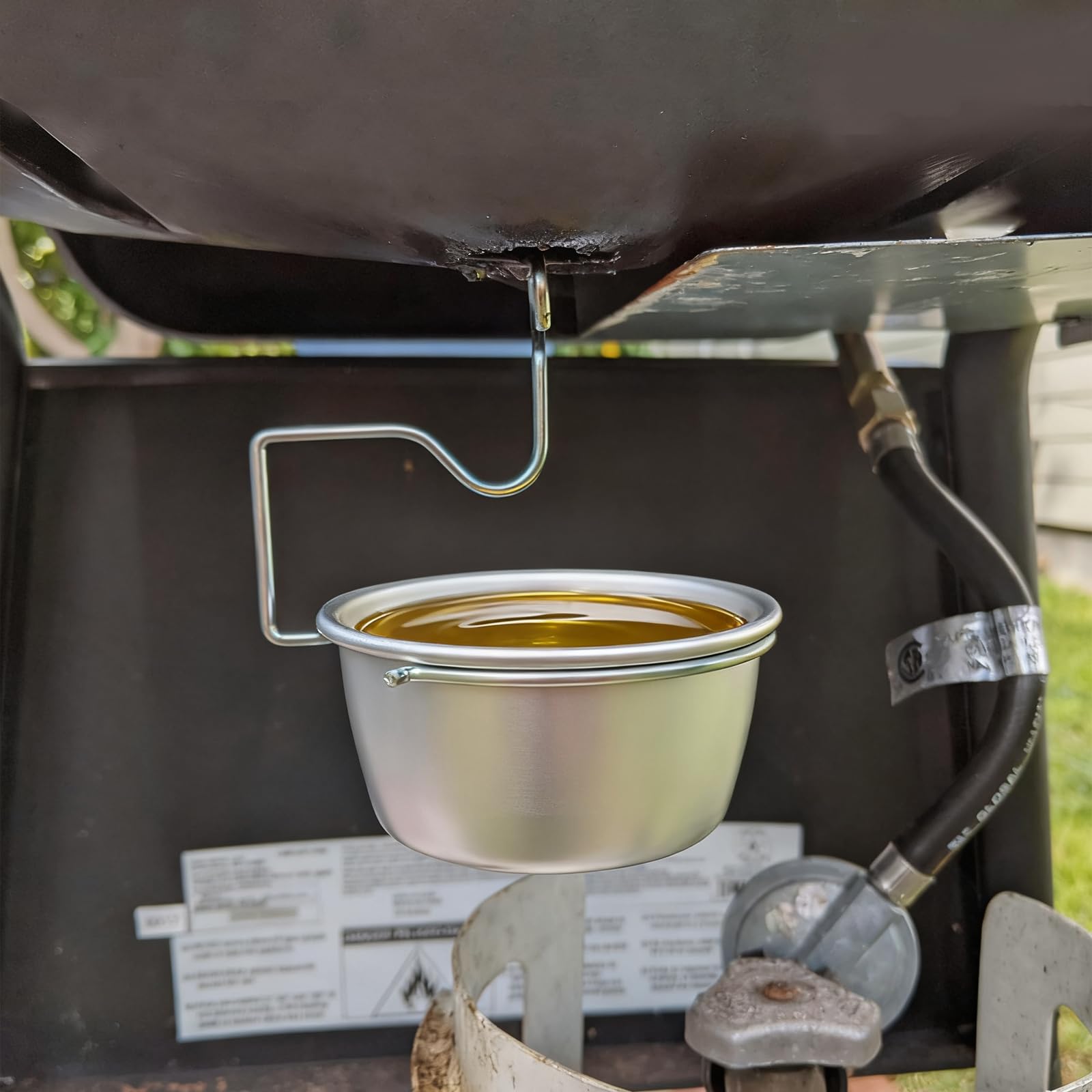 TAILGRILLER grease cup clip-hang keeps the tray steady during cooking
