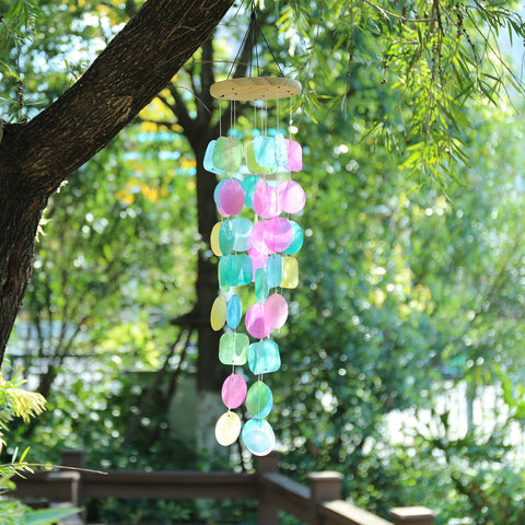 Taman capiz shells wind chime reflects sunlight for a shimmering garden display.
