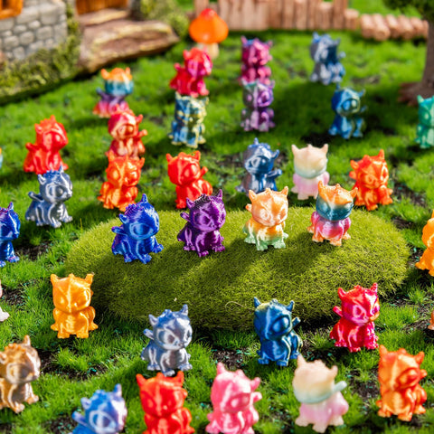 Teenzee 3D printed animals in varied colors for desk decor.
