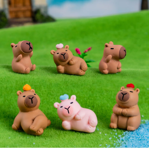 Colorful capybara miniatures for fairy garden scenes.