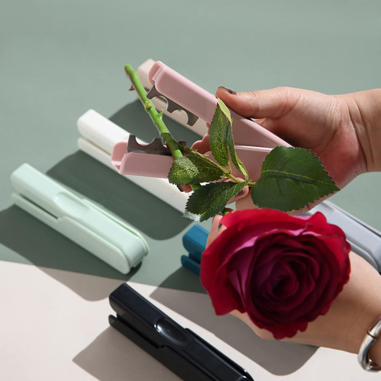TEONEI tool in hand demonstrates quick thorn removal for cleaner flower arrangements.