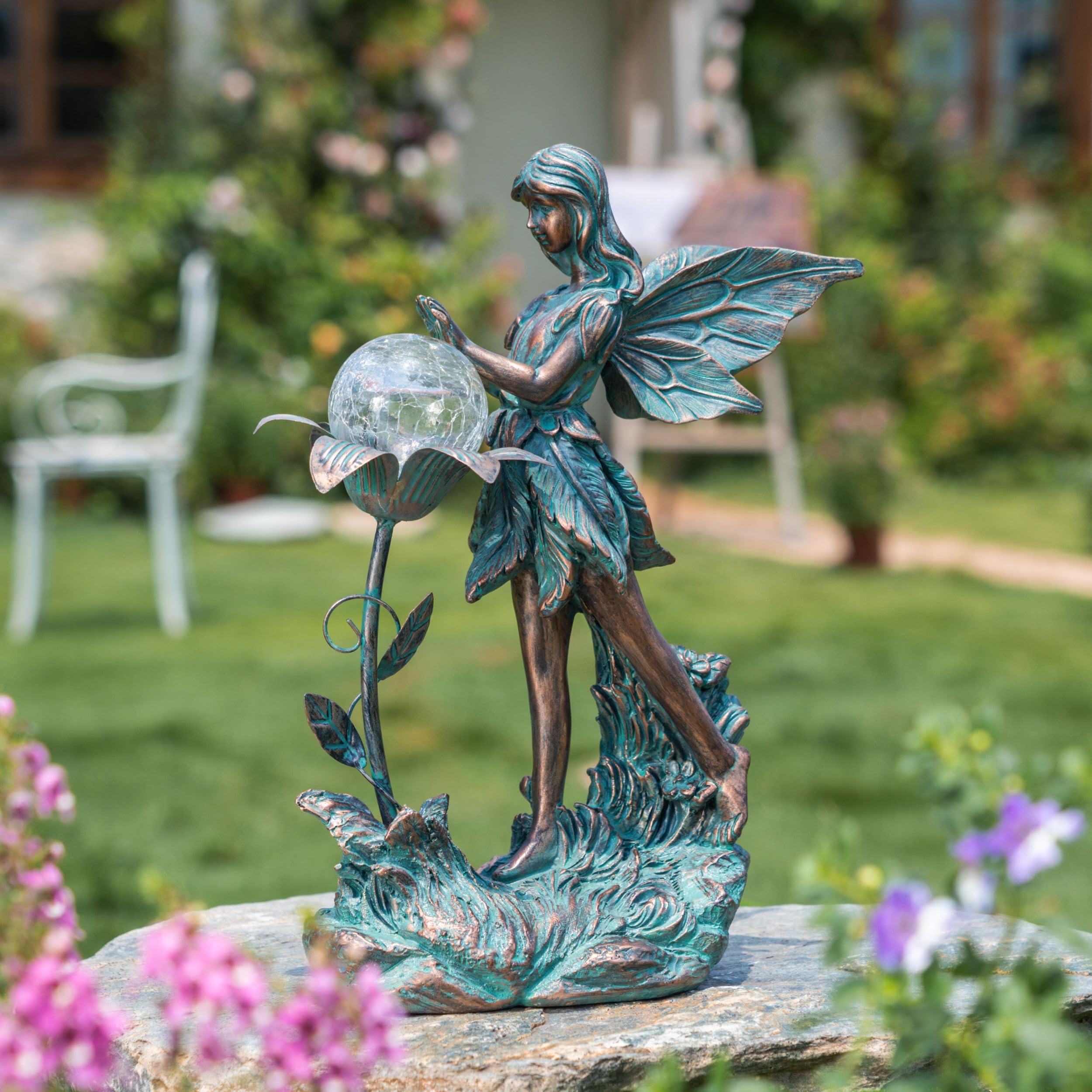 Solar-powered garden fairy glows along patio and walkway for ambiance.