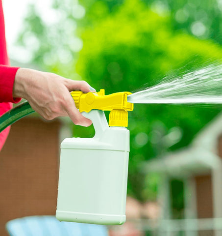 Filling the 32oz bottle quickly for efficient spray sessions in the yard.