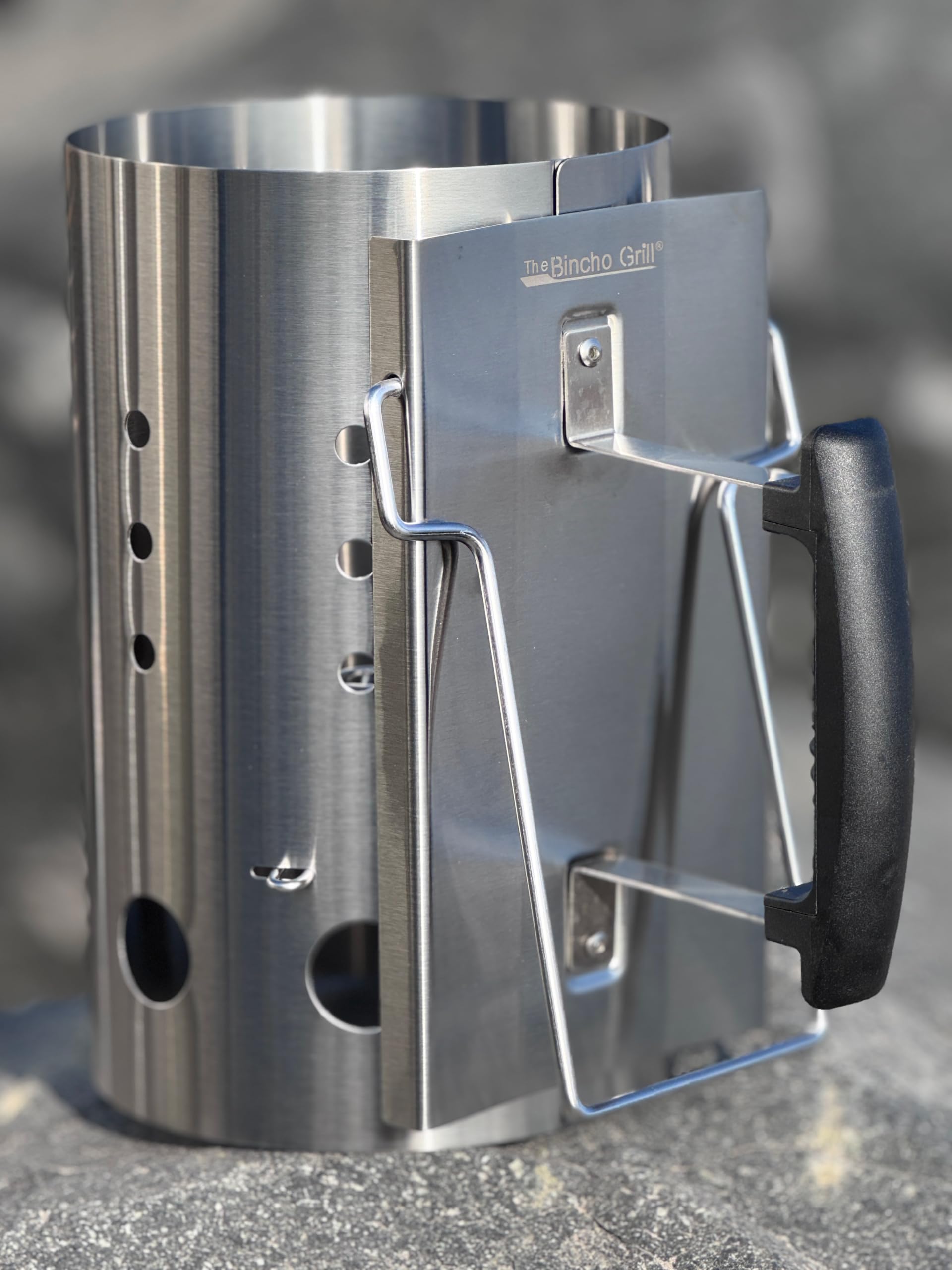 Integrated secondary handle aids two-handed transfer of hot charcoal.