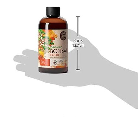 The Grow Co Bonsai Fertilizer pour demonstrates simple, precise dosing for indoor care.