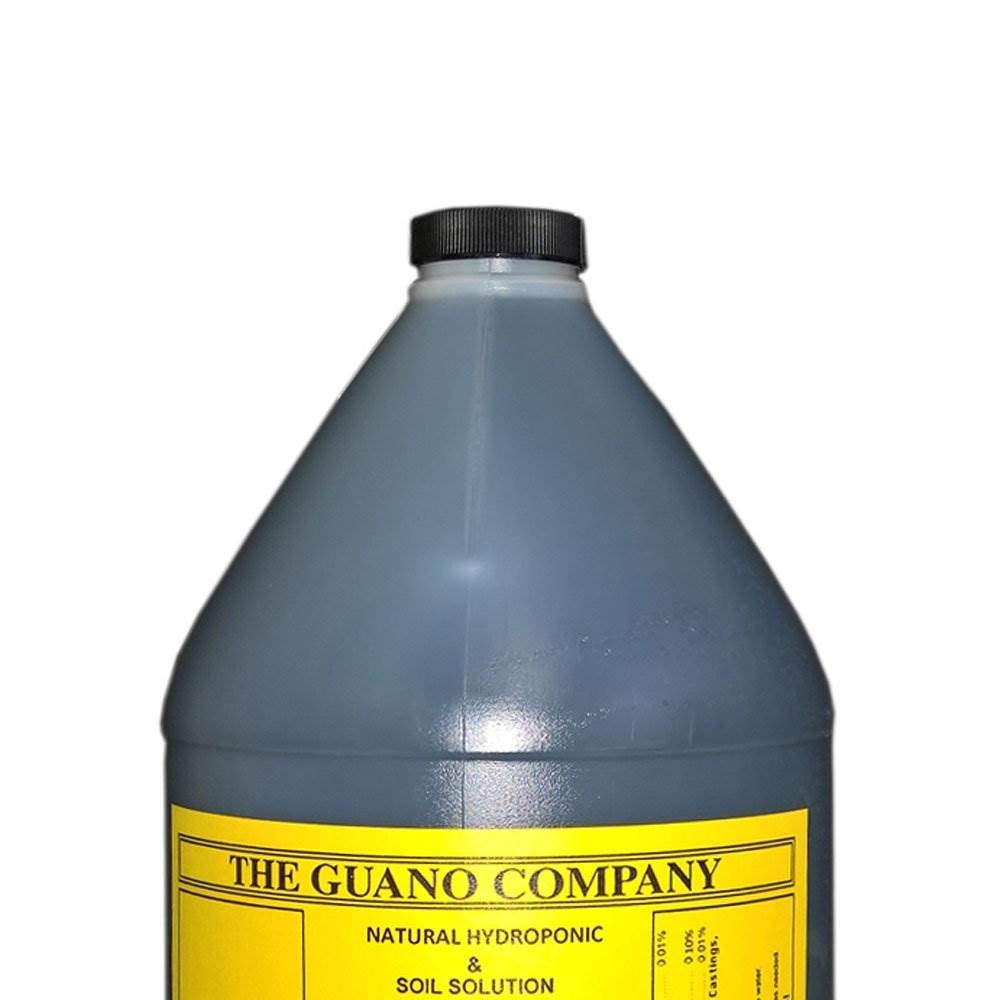 The Guano Company Budswel bottle beside flowering plants ready for bloom boost.