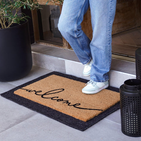 Theodore Magnus door mat with non-slip backing provides stable placement at the entry.