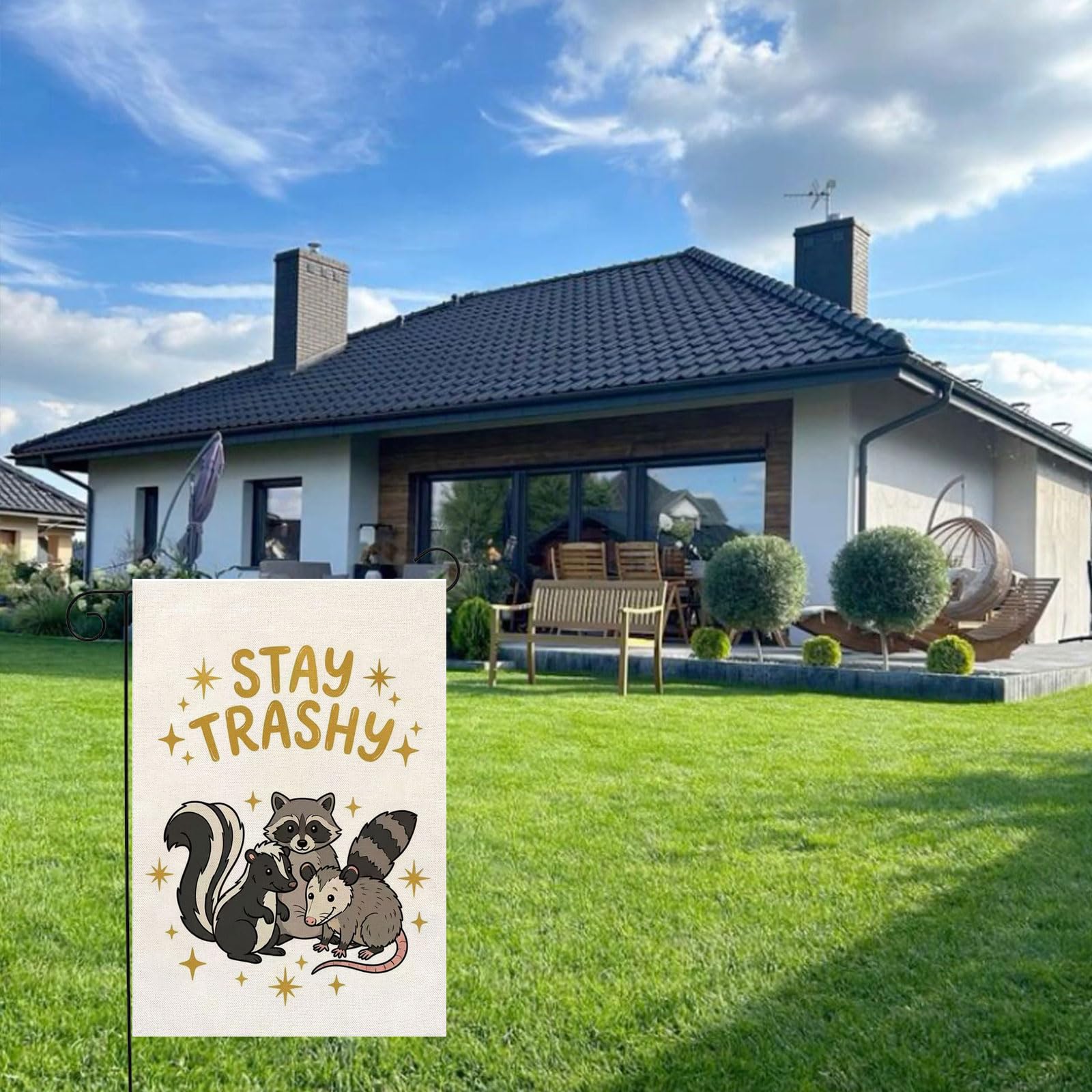 Thriano Stay Tashy Raccoon flag hanging on porch welcomes guests with whimsy.