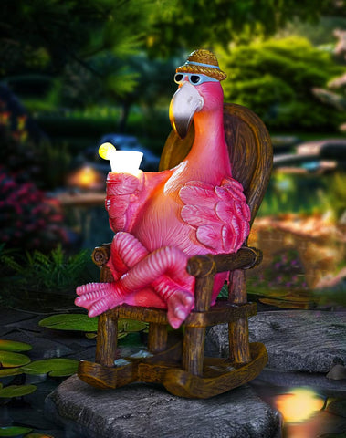 Tiejiajiang flamingo rocking chair statue sits in a sunny garden, adding outdoor charm.