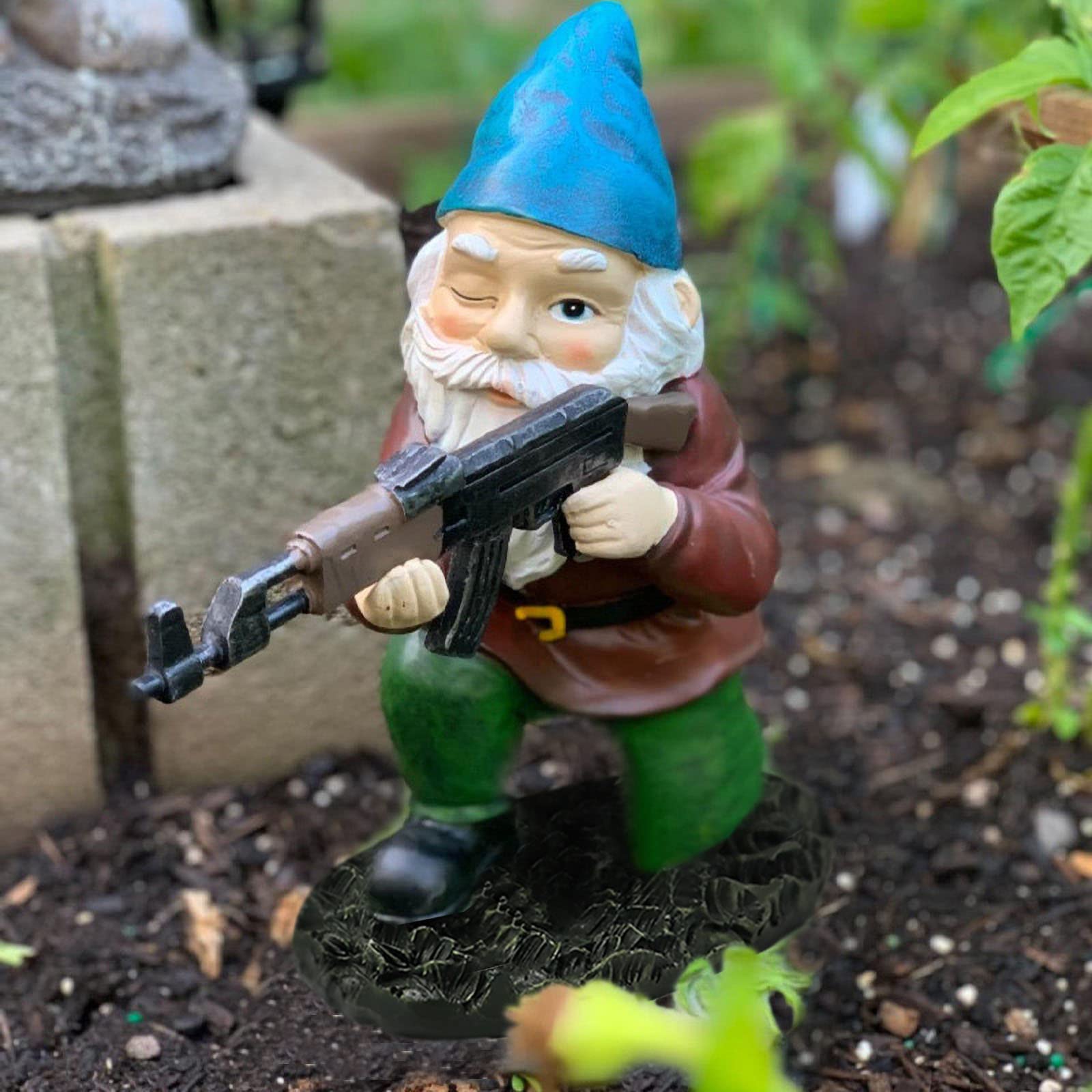 Tirifer garden statue gnome with gun enhances outdoor charm.
