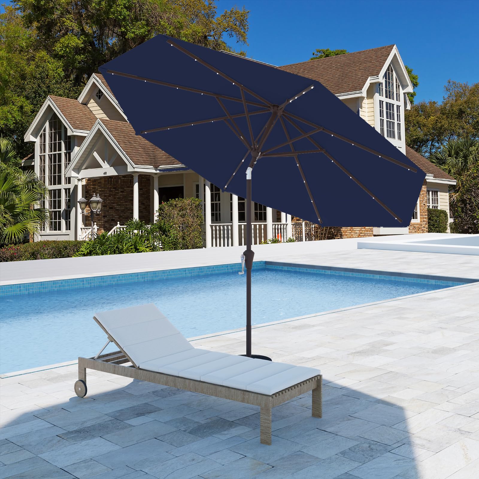 Tobeos navy umbrella over a stylish outdoor dining setup by the pool