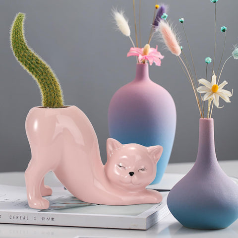 TOIVO pink cat planter pot with succulent in indoor setting