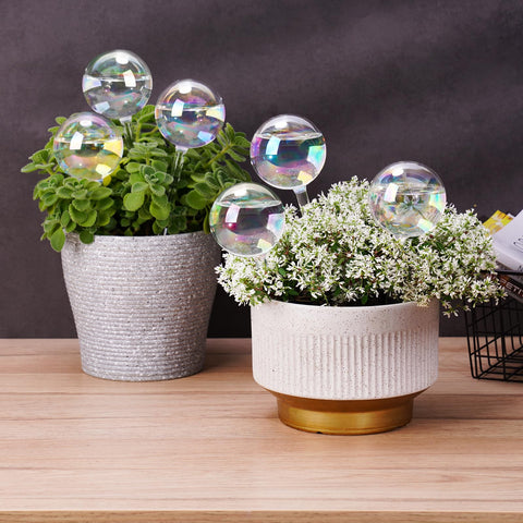 Tomorotec mini irrigation system glows with iridescent hues while watering.