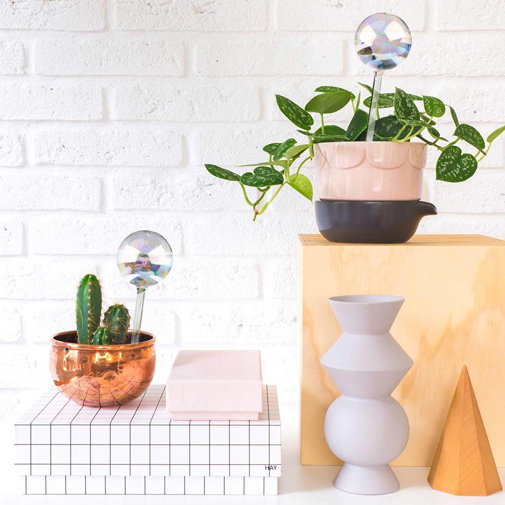 Tomorotec two-pack rainbow glass spikes, decorative irrigation that blends with soil.