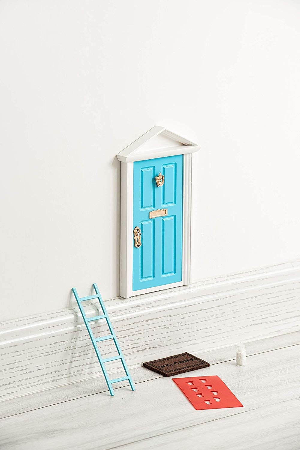 Tonttuovi fairy door on the wall with open panel for imaginative play and note exchanges.