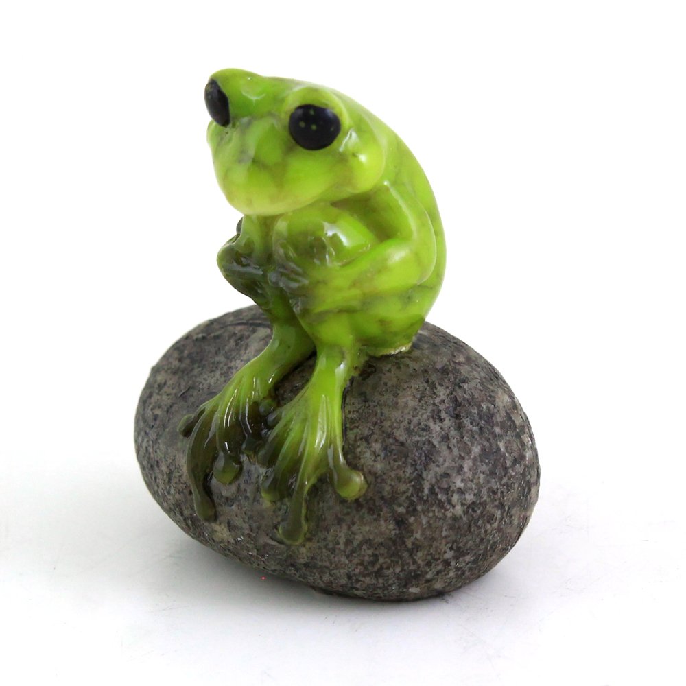 Top Collection frog on stone figurine in a fairy garden enhances whimsical outdoor display.