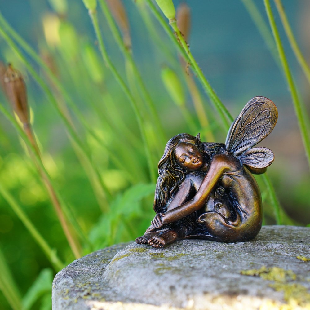 Hand-painted resin fairy figurine with intricate details for cozy decor.