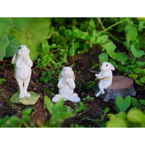 Top Collection ivory bunny statue reading on stump adds whimsy to small garden displays.