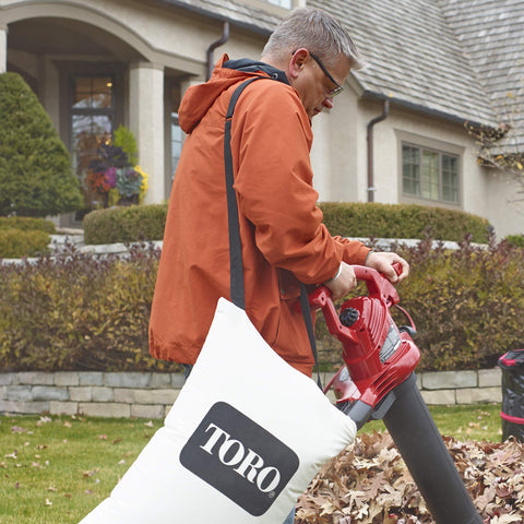 Toro 51503 bottom-zip bag attached to vacuum collar with comfort strap.