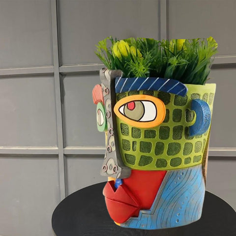 TOZLU Picasso face planter in colorful resin adds sculptural charm to shelves or patios.