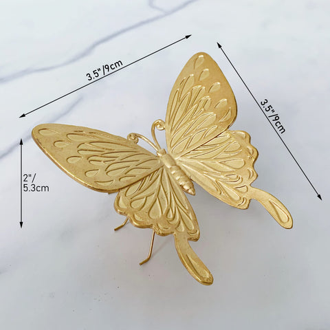 Tricune gold butterfly sculpture on a desk setup, ideal vanity or office decor.