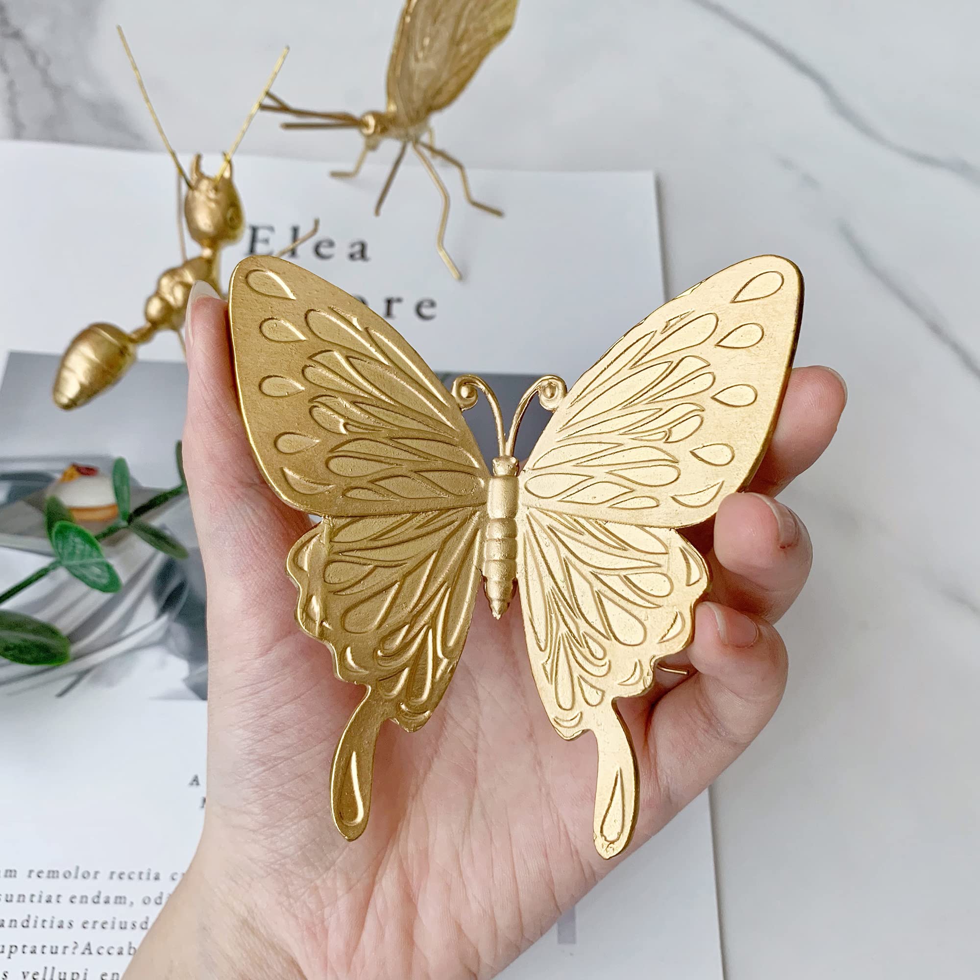 Tricune gold butterfly sculpture on vanity-table display, adds subtle luxury.