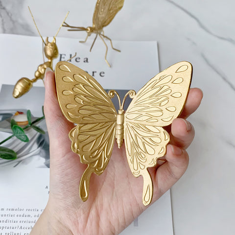 Tricune gold butterfly sculpture on vanity-table display, adds subtle luxury.
