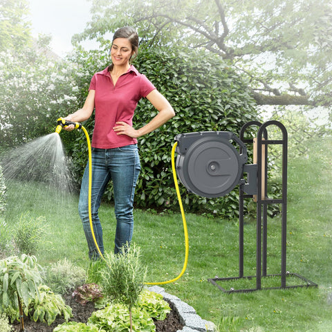 Trieez freestanding outdoor hose holder placed in a garden corner for easy watering.